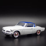 1:64 diecast model car with light gray body, blue roof, red wheel rims