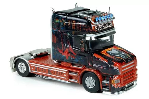 Scania Steininger diecast tractor model car in red and black, front-left view.