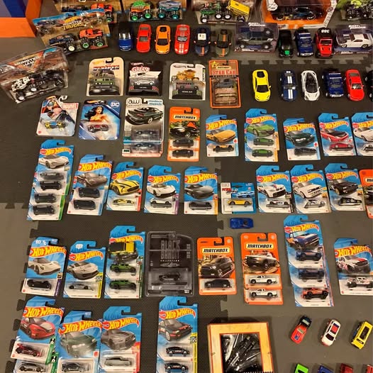 Hot Wheels diecast car and truck lot, boxed vehicles on display