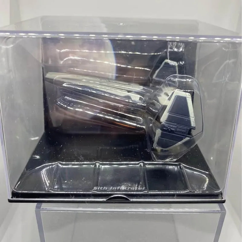 Diecast model vehicle in clear display box, dark and blue details