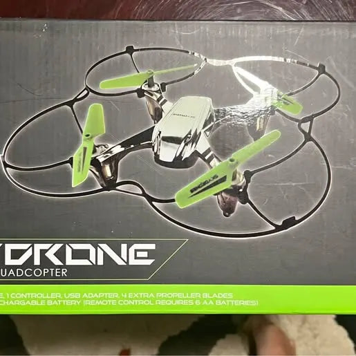 Quadcopter drone with clear frame and green prop guards, front view