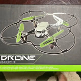 Quadcopter drone with clear frame and green prop guards, front view