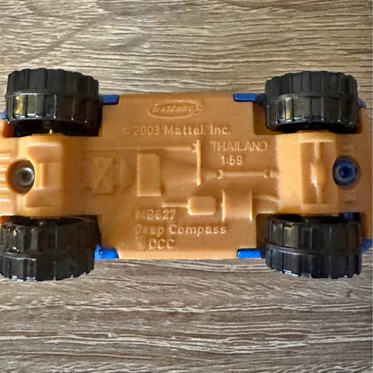 Diecast toy car with tan body and black wheels