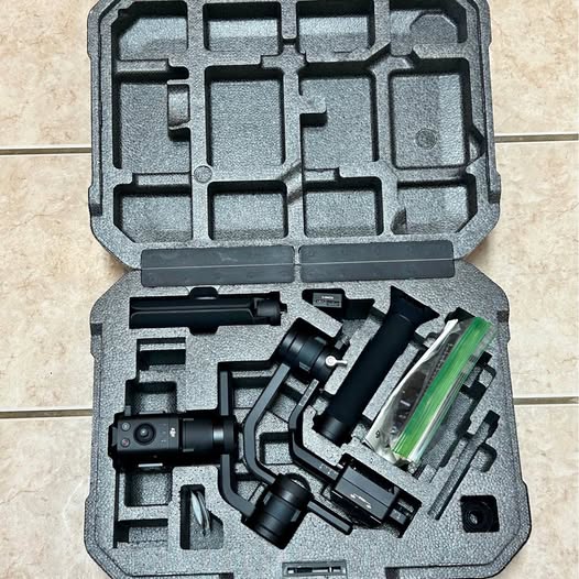 Camera gimbal stabilizer in hard foam case with mounted handle and motors