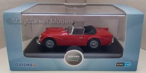 Red 1:43 diecast sports car model in clear display box