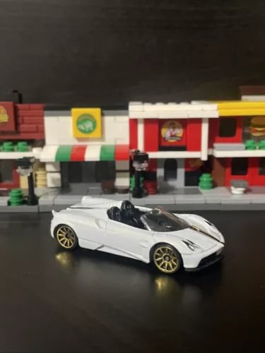 White roadster diecast model car, 1/64 scale, with black wheels
