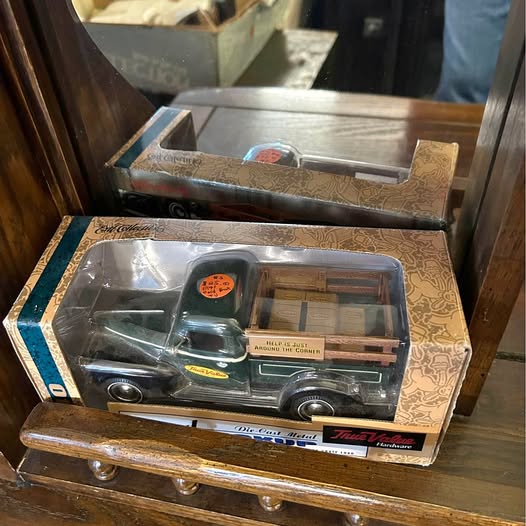 Metallic green diecast truck coin bank with slot on top, in decorative box
