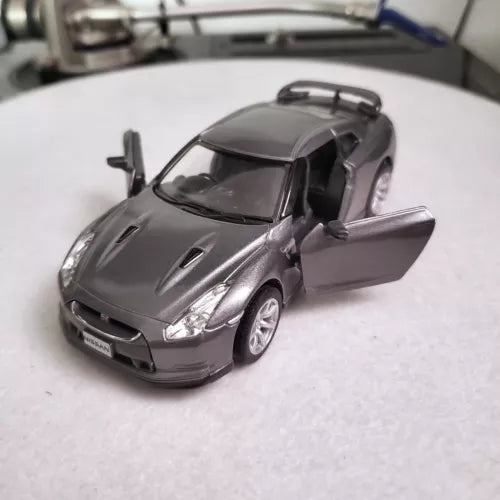 Gray diecast sports car toy with front view, door open