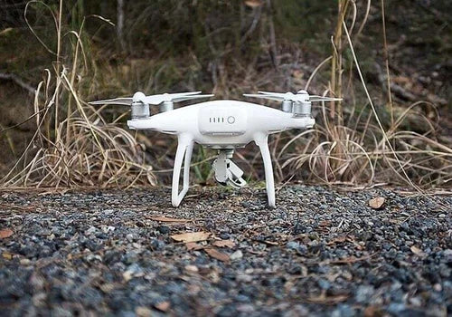 DJI Phantom 4 quadcopter drone with four white propellers