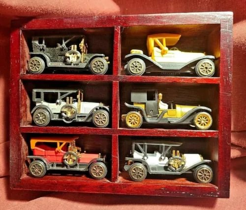 Diecast miniature antique cars in wooden display case, six mixed-color cars