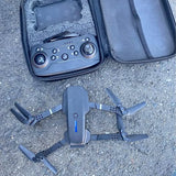 Foldable quadcopter drone with remote controller in zippered case