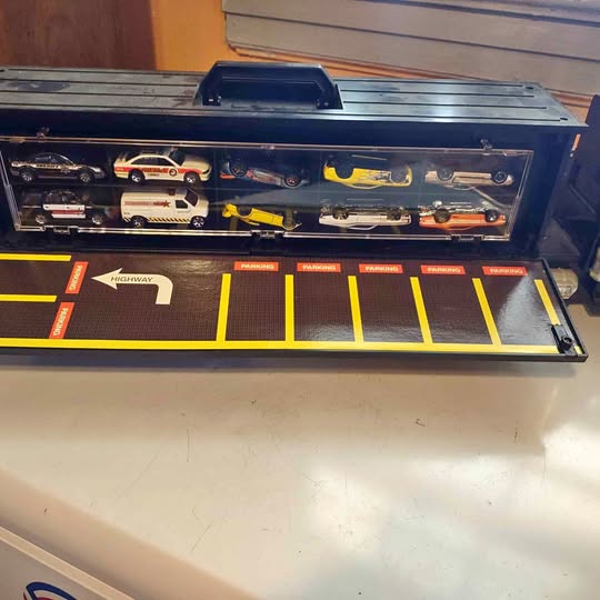 Diecast storage case with open tray, numbered slots and miniature car display
