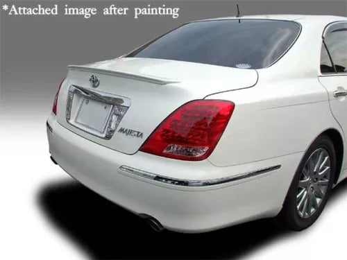 White diecast toy car model with red taillights, chrome bumper, rear three-quarter view