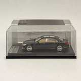 Black diecast sedan toy car model in clear display case, silver wheels