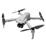 White quadcopter drone with four propellers and front gimbal camera module
