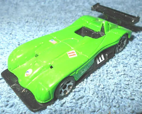 Green diecast race car with black wing and side graphics