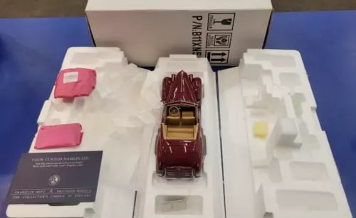 Maroon 1:24 diecast Packard Victoria convertible model in open packaging tray