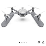 Grey quadcopter drone with four propellers and front spherical camera module