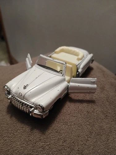 White diecast convertible car toy with open door, 1:36 scale, detailed interior