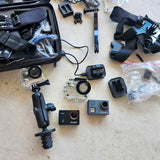 Drone and action camera kit with remote, spare parts, and charging accessories