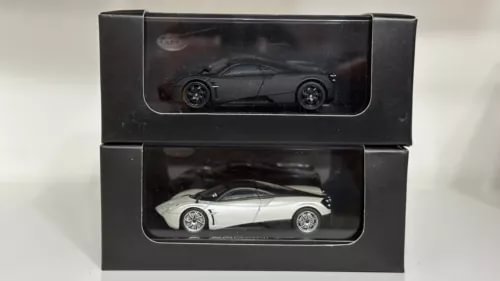 Pagani Huayra diecast car set in black and white, shown in two display boxes