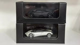 Pagani Huayra diecast car set in black and white, shown in two display boxes