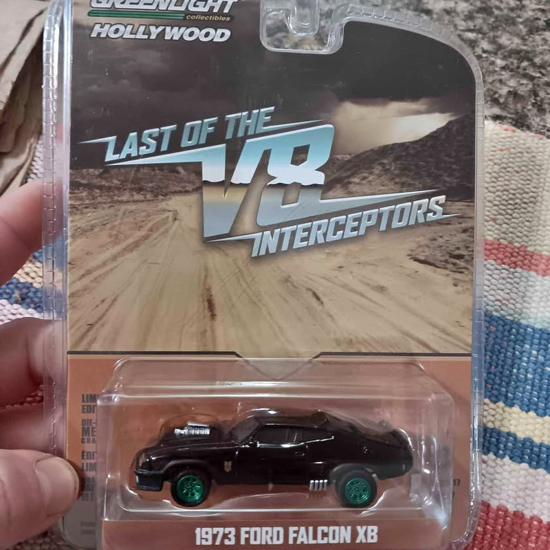 1973 Ford Falcon XB diecast model car, dark green wheels, in blister package