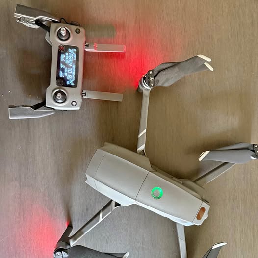 Folded quadcopter drone with four arms and propellers, viewed from above