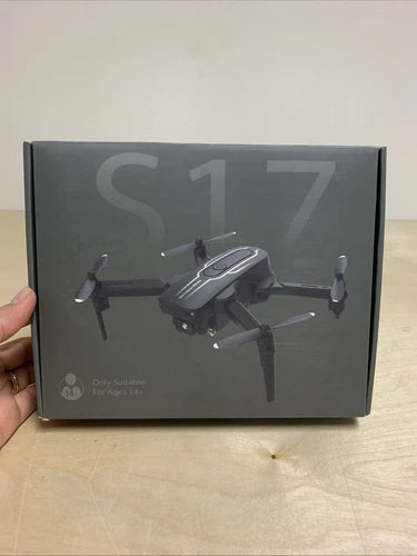 Mini drone with camera shown on retail box, four propeller arms and camera module