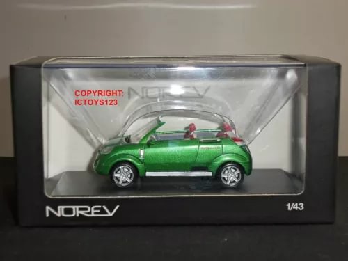 Green diecast model car of NOREV OPEL Frogster in clear display box, side view.