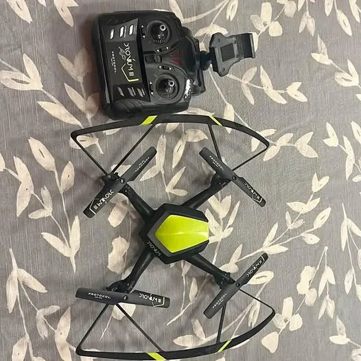 Black quadcopter drone with four propellers and lime-green accents