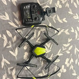 Black quadcopter drone with four propellers and lime-green accents