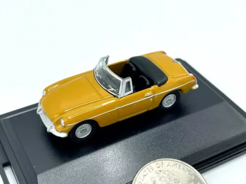 Yellow diecast convertible car with black interior and silver trim