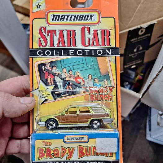 Matchbox diecast car in blister pack, yellow station wagon, Brady Bunch theme