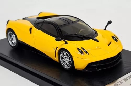 Yellow supercar diecast model car with black roof and front grille details, front 3/4 view