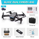 Black dual-camera quadcopter drone kit with storage bag, remote, and manual.