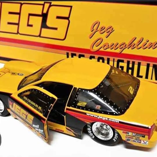 Diecast pro stock car model, yellow with black windows and red stripe, 1/24 scale