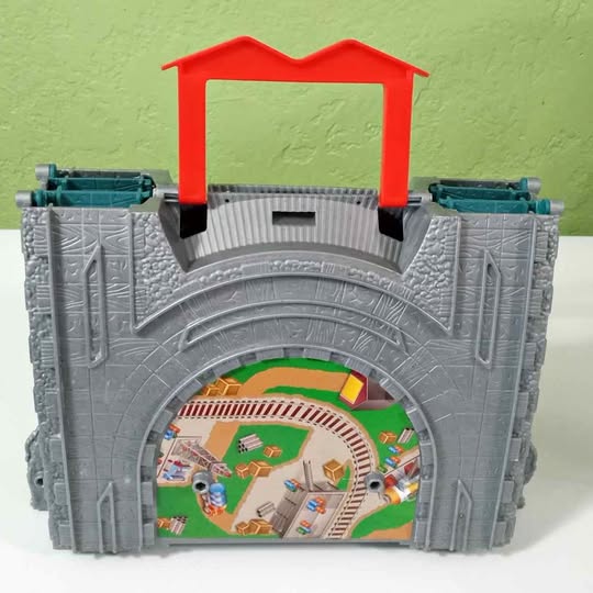 Grey travel track playset with red engine gate and built-in archway