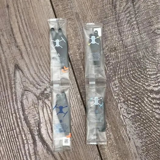Drone propeller replacement set in two sealed foil packets, labels A and B