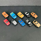 Diecast toy cars and trucks assortment in orange, blue, yellow, black, red, and beige