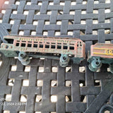Diecast train model car, pinkish-red side with windows and Pennsylvania lettering