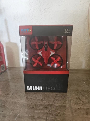 Mini UFO toy drone in retail box, 8+ ages, red quadcopter prop design