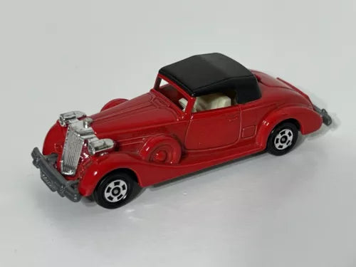Red diecast coupe roadster model car with black roof, chrome details