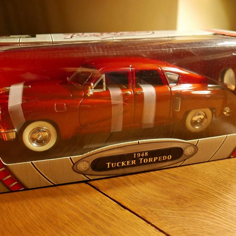Diecast Tucker Torpedo model car with red body and white racing stripes