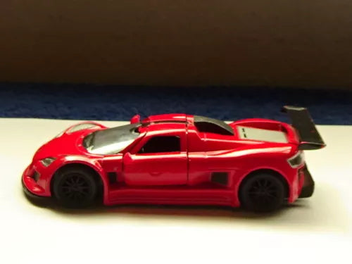 Red diecast sports car with rear spoiler and open hood, 5 in long