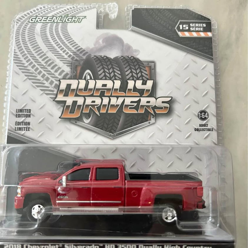 Red 1/64 scale diecast pickup truck with open bed, in retail blister packaging