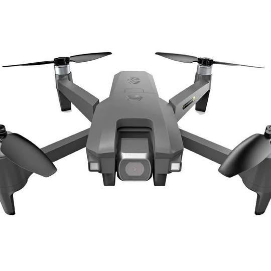 Gray foldable quadcopter drone with four propellers and front camera