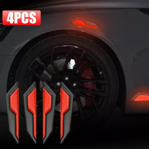 Black mini diecast car wheel with red side accents and brake detail