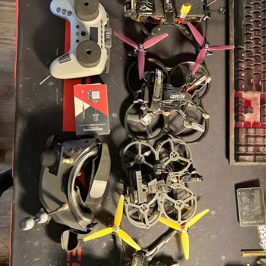 Quadcopter drone frame with propellers and starter kit components, including batteries