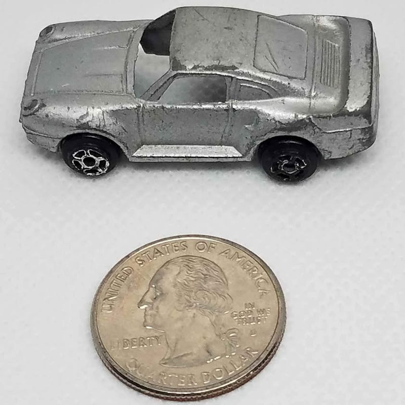 Silver diecast sports car model with detailed hood and rear spoiler, angled front view